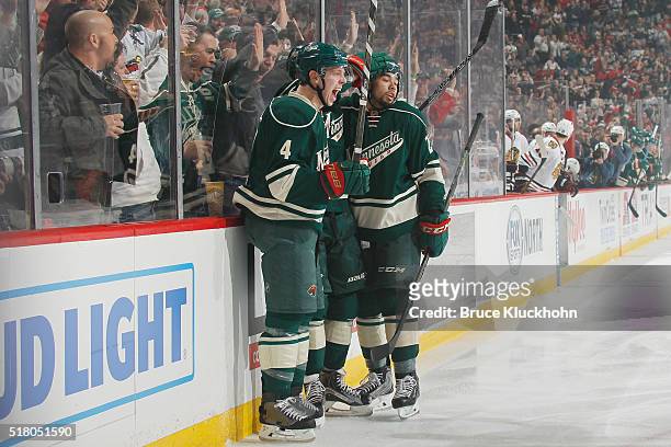 Mike Reilly, Jarret Stoll, and Matt Dumba of the Minnesota Wild celebrate after scoring a goal against the Chicago Blackhawks during the game on...