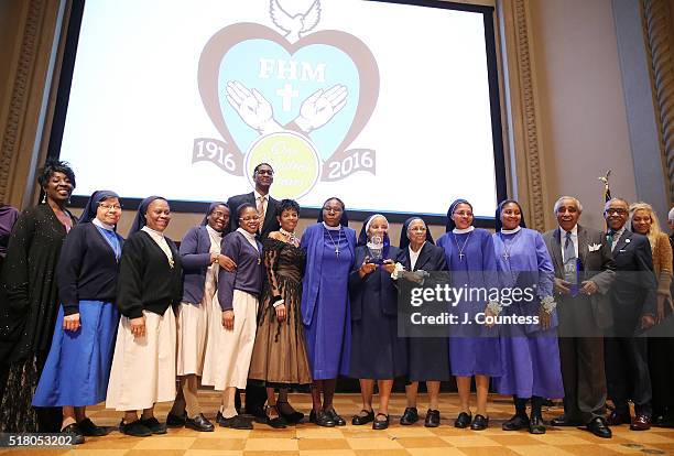 Honorees and presentors join members of the Franciscan Handmaids Of The Most Pure Heart of Mary onstage for a photo during the 2016 Franciscan...
