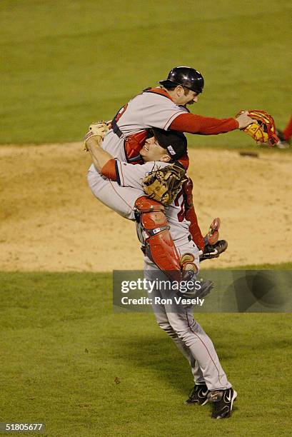 Pitcher Keith Foulke and catcher Jason Varitek of the Boston Red Sox celebrate after winning game four of the 2004 World Series against the St. Louis...