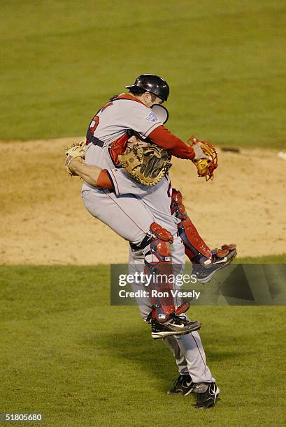 Pitcher Keith Foulke and catcher Jason Varitek of the Boston Red Sox celebrate after winning game four of the 2004 World Series against the St. Louis...