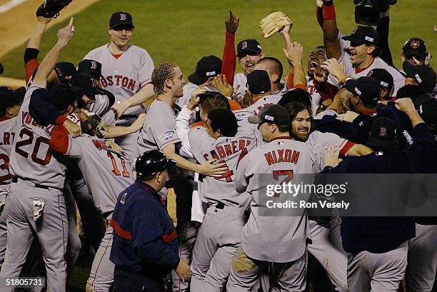 The Boston Red Sox celebrate after winning game four of the 2004 World Series against the St. Louis Cardinals at Busch Stadium on October 27, 2004 in...