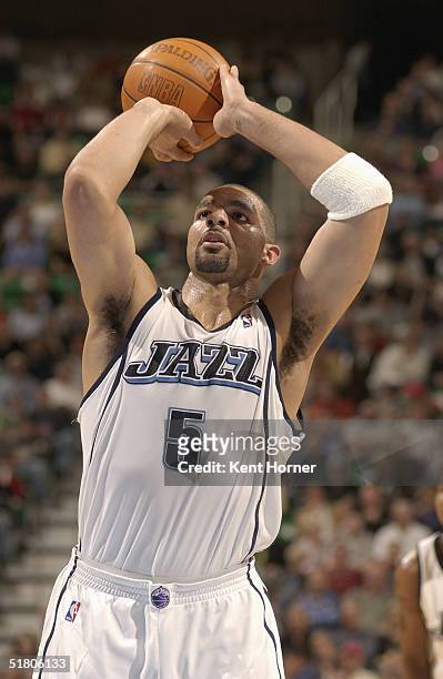 Carlos Boozer of the Utah Jazz shoots a free throw against the Detroit Pistons on November 13, 2004 at the Delta Center in Salt Lake City, Utah. The...