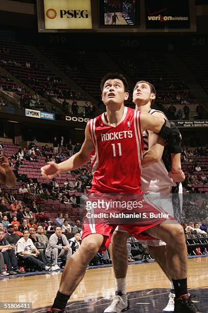 Yao Ming of the Houston Rockets looks for a rebound during the game against the New Jersey Nets on November 15, 2004 at the Continental Airlines...