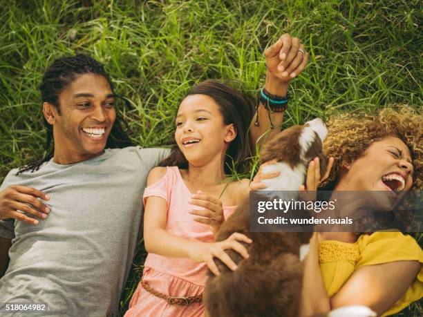 top view shot of african-american family lying on their backs - family garden play area stock pictures, royalty-free photos & images