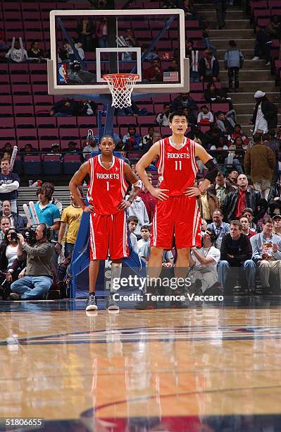 Tracy McGrady stands with Yao Ming of the Houston Rockets during the game against the New Jersey Nets on November 15, 2004 at the Continental...