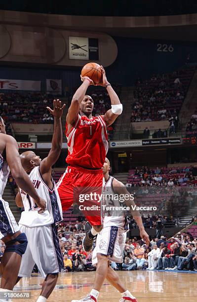 Tracy McGrady of the Houston Rockets shoots during the game against the New Jersey Nets on November 15, 2004 at the Continental Airlines Arena in...