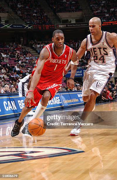 Tracy McGrady of the Houston Rockets moves the ball during the game against the New Jersey Nets on November 15, 2004 at the Continental Airlines...