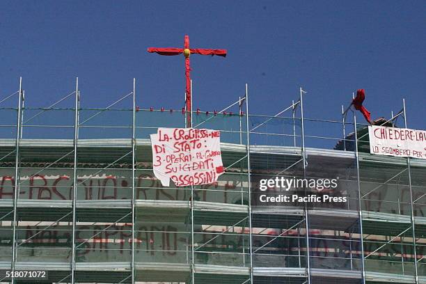 Protesters climbed on the roof of the Baronial Castle of Acerra and tied to the scaffold a red mannequin along with two banners, reads: "Chiedere...