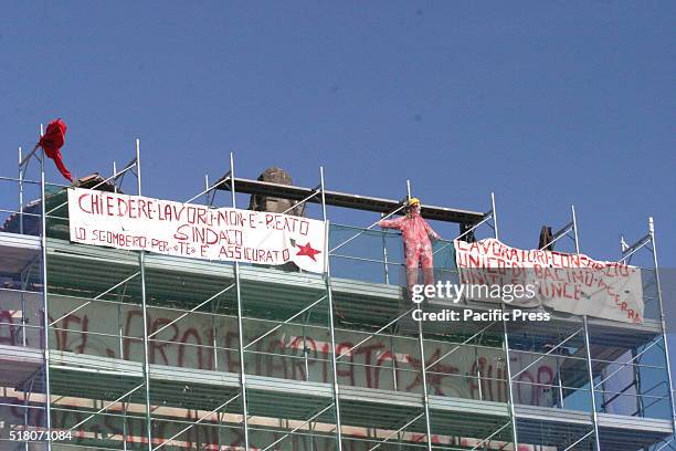Protesters climbed on the roof of the Baronial Castle of Acerra and tied to the scaffold a red mannequin along with two banners, reads: "Chiedere...