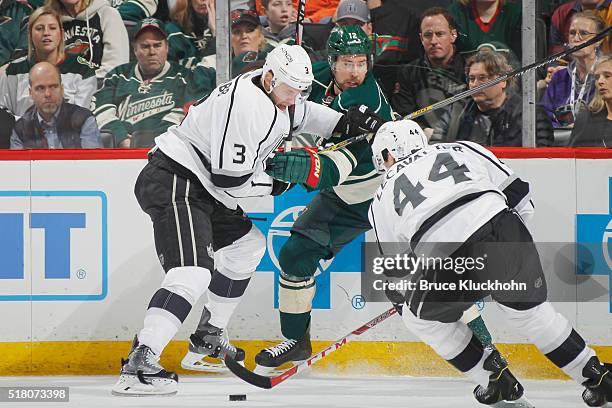 Brayden McNabb and Vincent Lecavalier of the Los Angeles Kings battle for the puck with David Jones of the Minnesota Wild during the game on March...