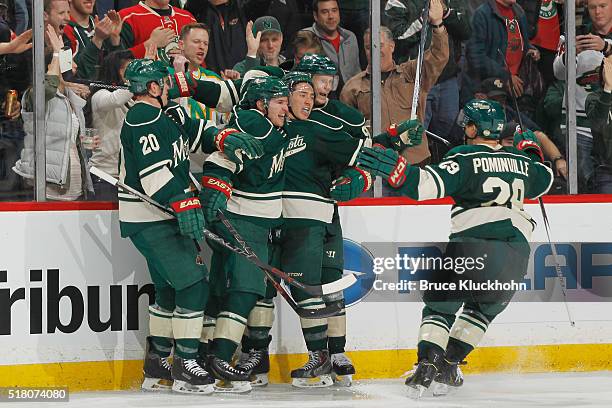 Ryan Suter, Zach Parise, Jared Spurgeon, Mikko Koivu, and Jason Pominville of the Minnesota Wild celebrate after scoring a goal against the Chicago...