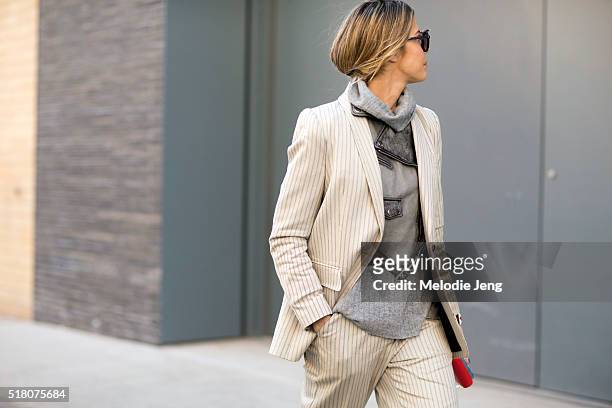 Martha Graeff wears cream-colored Zimmermann striped suit over a gray Diesel leather jacket, and gray turtleneck during New York Fashion Week:...