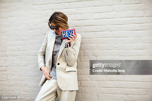 Martha Graeff wears cream-colored Zimmermann striped suit over a gray Diesel leather jacket, and gray sweater, Oxydo Society sunglasses, and a Les...