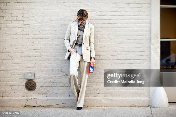 Martha Graeff wears cream-colored Zimmermann striped suit over a gray Diesel leather jacket, and gray sweater, Oxydo Society sunglasses, and a Les...