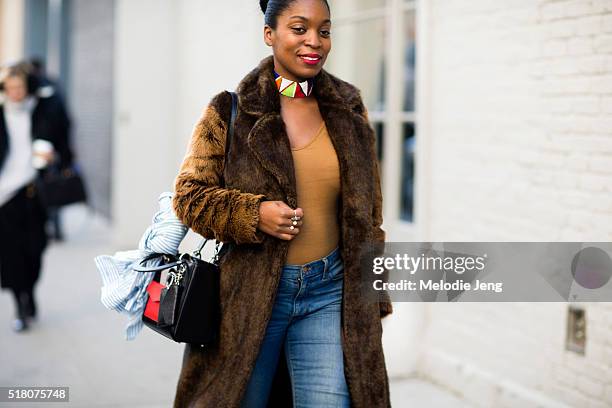 Rajni Jacques wears a needle and thraed choker, ASOS fur coat, Dior purse, and Madewell jeans before the Zimmermann show in Chelsea during New York...