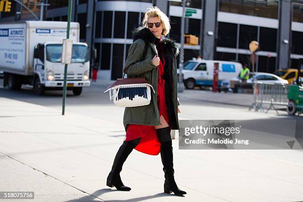 Zanita Whittington wears vintage sunglasses, a Mr & Mrs Italy green parka with a fur hood, a red Zimmermann robe-style dress, a Tod's wave bag, and...