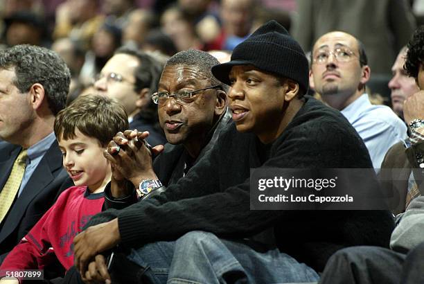 Owner Bob Johnson of the Charlotte Bobcats watches the game with part owner/entertainer Jay-Z of the New Jersey Nets on November 30, 2004 at the...