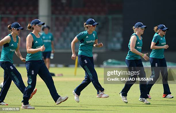 England captain Charlotte Edwards runs alongside teammates at a practice session at the Feroz Shah Kotla stadium in New Delhi on March 29, 2016 on...