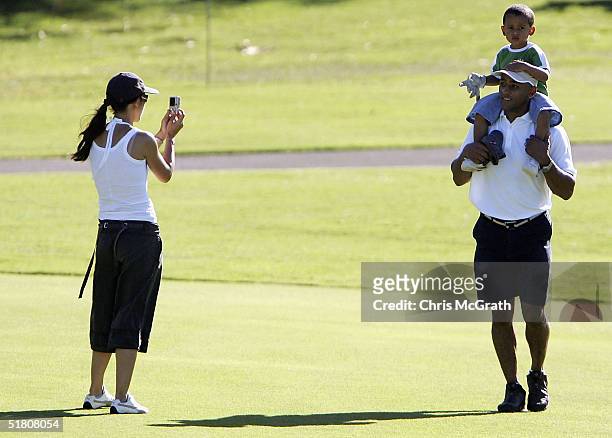 Wallabies captain George Gregan and son Max walk up the 13th fairway as wife Erica talkes a photo during the 2004 Australian PGA Championship Pro-Am...