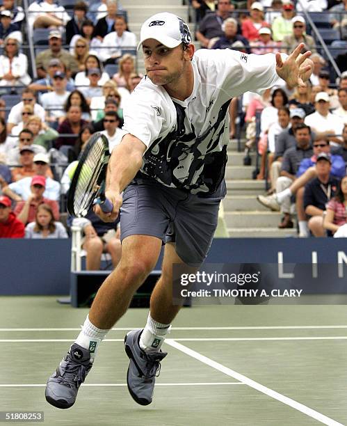 Number 2 seed Andy Rodidick of the United States returns a shot to Guillermo Canas of Argentina during their match at the 2004 US Open in Flushing...