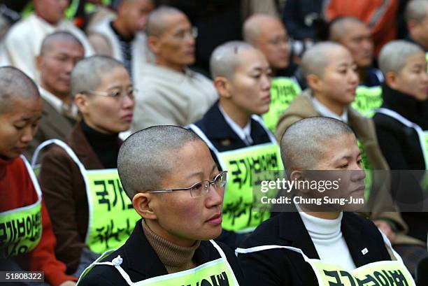 Protesters attend a demonstration after having their heads shaved at a protest to demand the abolition of the National Security Law which prescribes...