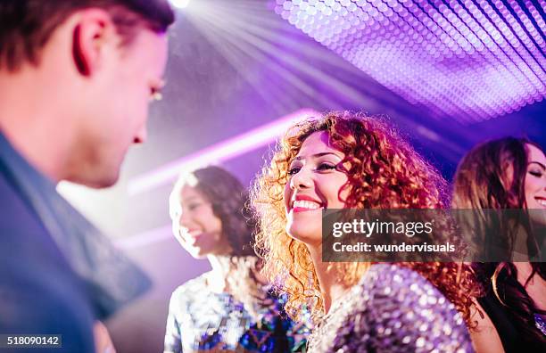 teen girl flirting with a guy in a night club - disco lights stock pictures, royalty-free photos & images