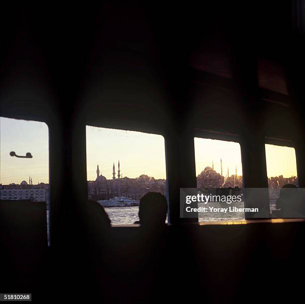 Suleymaniye Mosque and Yeni Cami are seen from a ferry boat, crossing the Bosphorus Strait from Eminonu station on the European side of Istanbul to...