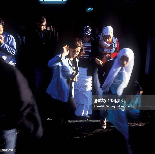 Young Turkish women get off a ferry boat in Eminonu station, on the European side of Istanbul in the early morning on October 16, 2004 in Turkey. The...