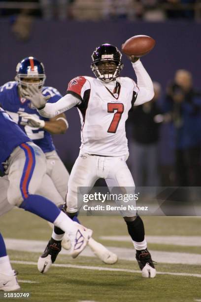 Quarterback Michael Vick of the Atlanta Falcons sets to pass during the game against the New York Giants at Giants Stadium on November 21, 2004 in...