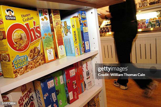 Customer walks past boxes of cereal at Cereality Cereal Bar and Cafe December 1, 2004 in Philadelphia, Pennsylvania. Cereality sells almost any...