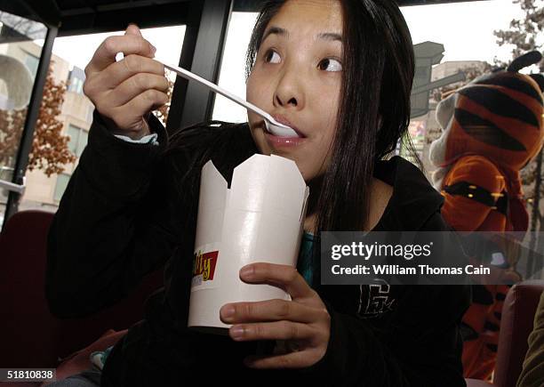 Lisa Chau, 20-years-old of San Diego, California has a bowl of cereal at Cereality Cereal Bar and Cafe December 1, 2004 in Philadelphia,...