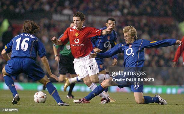 Manchester United's Liam Miller fights for the ball with Arsenal's Mathieu Flamini and Sebastian Larsson during their Carling Cup quater final...