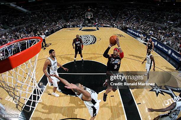 Guard Allen Iverson of the Philadelphia 76ers takes a jumpshot against Tony Parker of the San Antonio Spurs on December 1, 2004 at the SBC Center in...