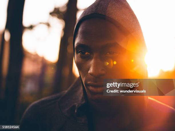 close up shot with lens flare of determined african-american ath - effort face stock pictures, royalty-free photos & images