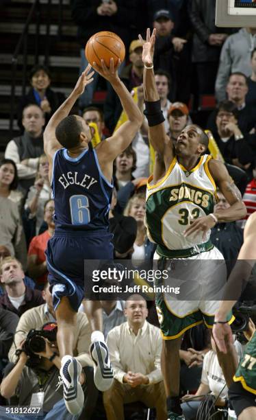 Howard Eisley of the Utah Jazz shoots against Antonio Daniels of the Seattle SuperSonics on December 1, 2004 at Key Arena in Seattle, Washington....