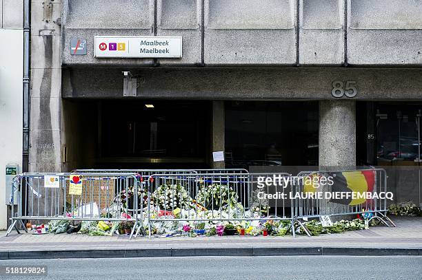 Picture taken on March 30, 2016 outside the Maalbeek / Maelbeek metro station in Brussels shows a makeshift memorial for the victims of last week...