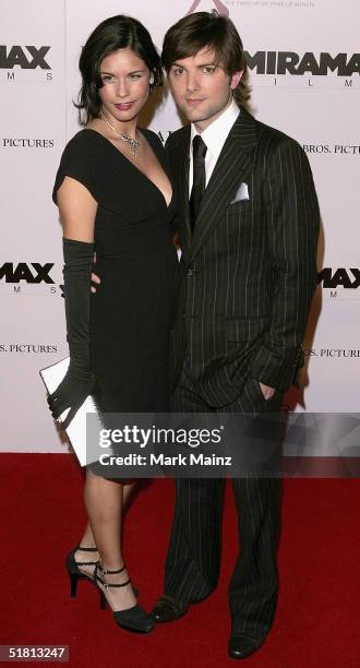 Actor Adam Scott and Naomi Sablan attends the premiere of "The Aviator" at Mann's Chinese Theatre on December 1, 2004 in Hollywood, California.