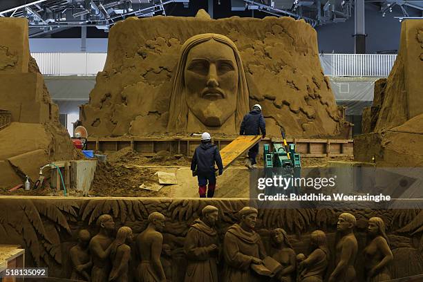 Helpers transport wood frame in the sight, ahead of the eight annual exhibition 'World Travel By Sand - South Africa' at the Tottori Sand Dunes The...