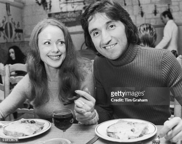 Photographer Ray Bellisario and his fiance, Annie Collins, enjoy a meal in a restaurant, 3rd October 1972.