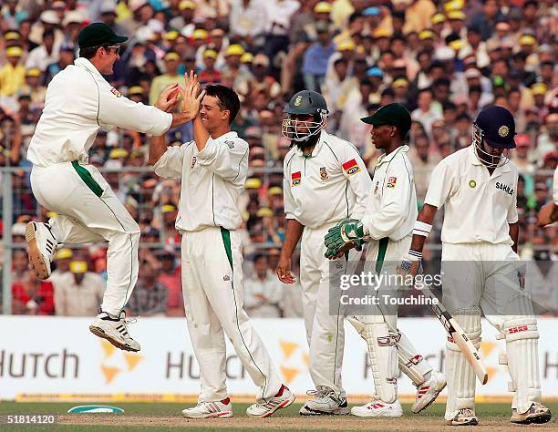 Jacques Rudolph and Graeme Smith of South Africa celebrate the wicket of Gautam Gambhir of India during day 5 of the second test between India and...