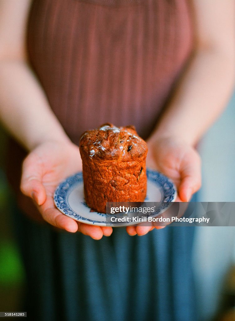 Woman holding russian easter bread kulich