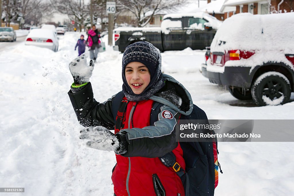 Winter day, child going to school: Young boy happily...