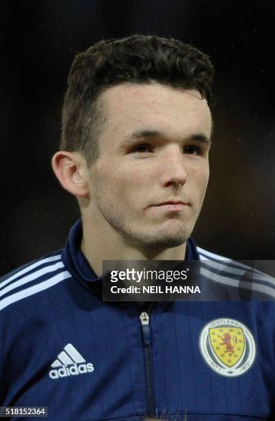Scotland's midfielder John McGinn stands during the national anthems at the start of the international friendly football match between Scotland and...