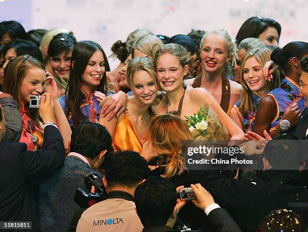 Sofie Oosterwaalal of the Netherlands poses for pictures with other contestants after winning the OLAY Elite Model Look 2004 International Finals on...