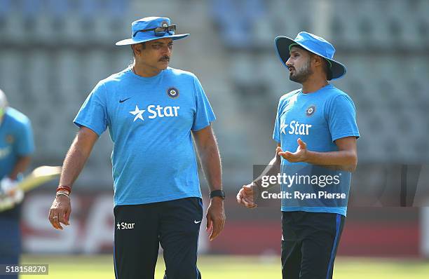 Ravi Shastri, Head Coach of India speaks with Harbhajan Singh of India during an India training session at Wankhede Stadium on March 30, 2016 in...