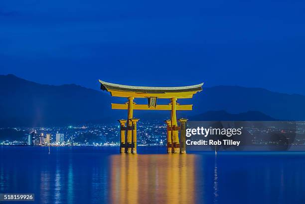 twilight floating torii gate - torii gate stock pictures, royalty-free photos & images