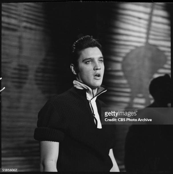 American rock and roll singer and actor Elvis Presley sings while dressed in a dark, short-sleeved shirt during his second appearance on the Ed...