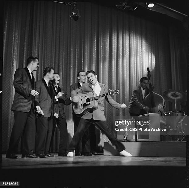 American rock and roll singer and actor Elvis Presley dances as he sings during his second appearance on the Ed Sullivan Show, New York, New York,...