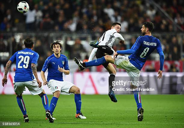 Julian Draxler of Germany is challenged by Thiago Motta of Italy during the International Friendly match between Germany and Italy at Allianz Arena...