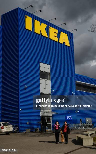 People walk outside Europe's biggest Ikea store is pictured in Kungens Kurva, south-west of Stockholm on March 30, 2016. - Ikea founder Ingvar...